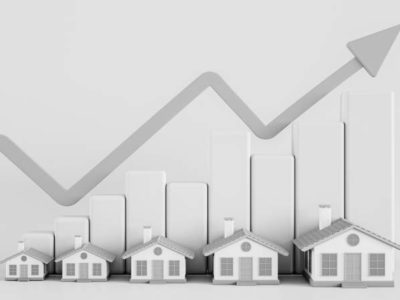 Black and white photo showing a graphic indicating house prices increasing.